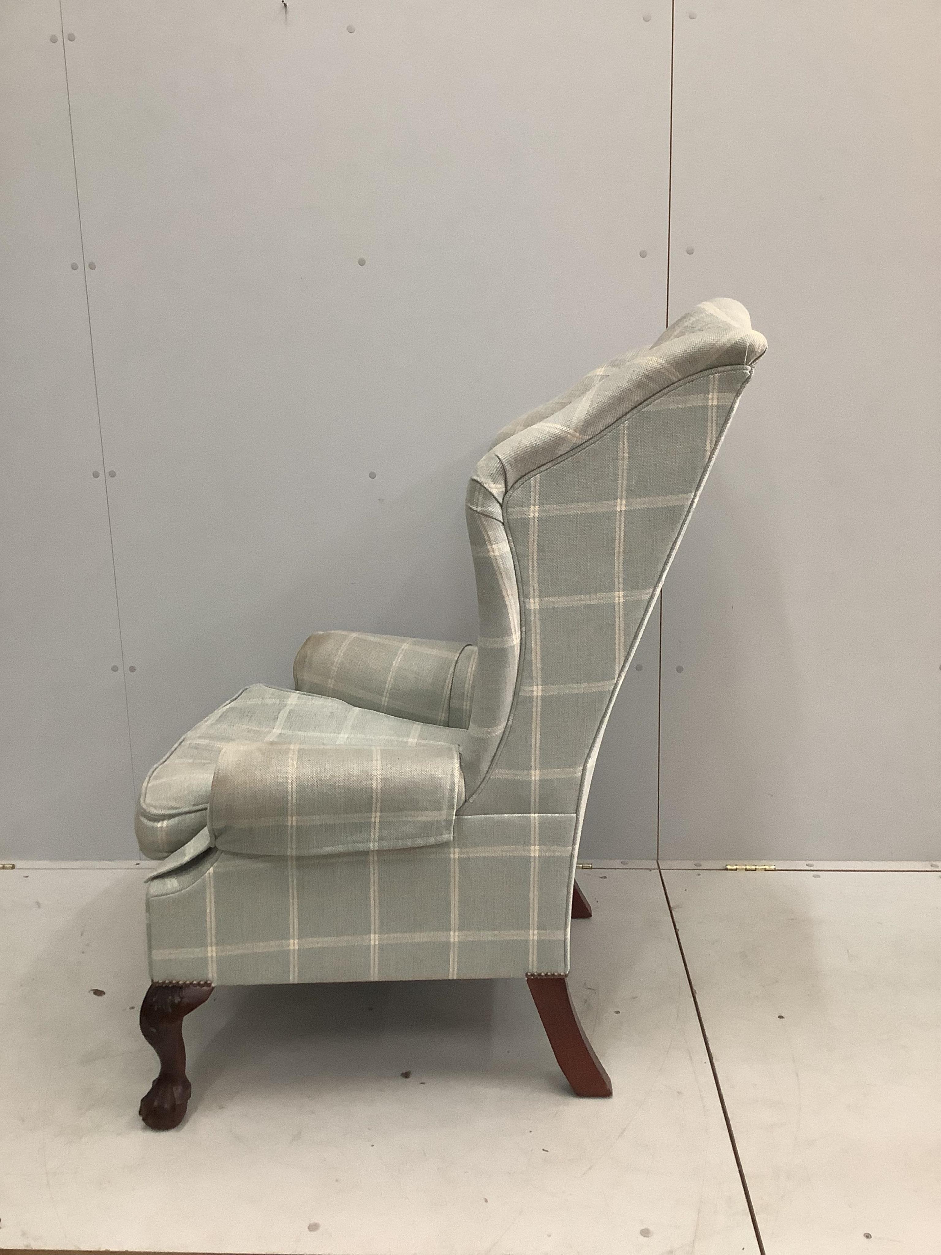 A George I style upholstered wingback armchair, by George Smith, width 79cm, depth 76cm, height 120cm. Condition - fair